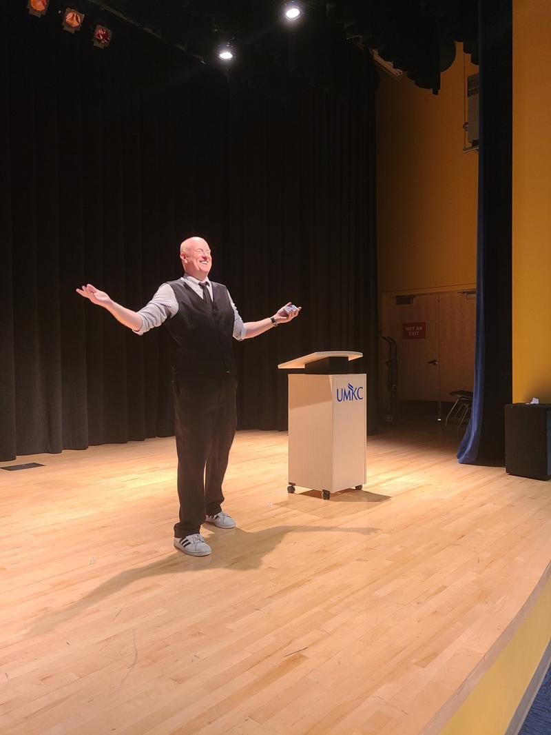 Corporate magician on stage performing for a company event in Kansas City