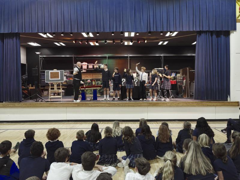 Cub Scout magic show with young volunteers on stage