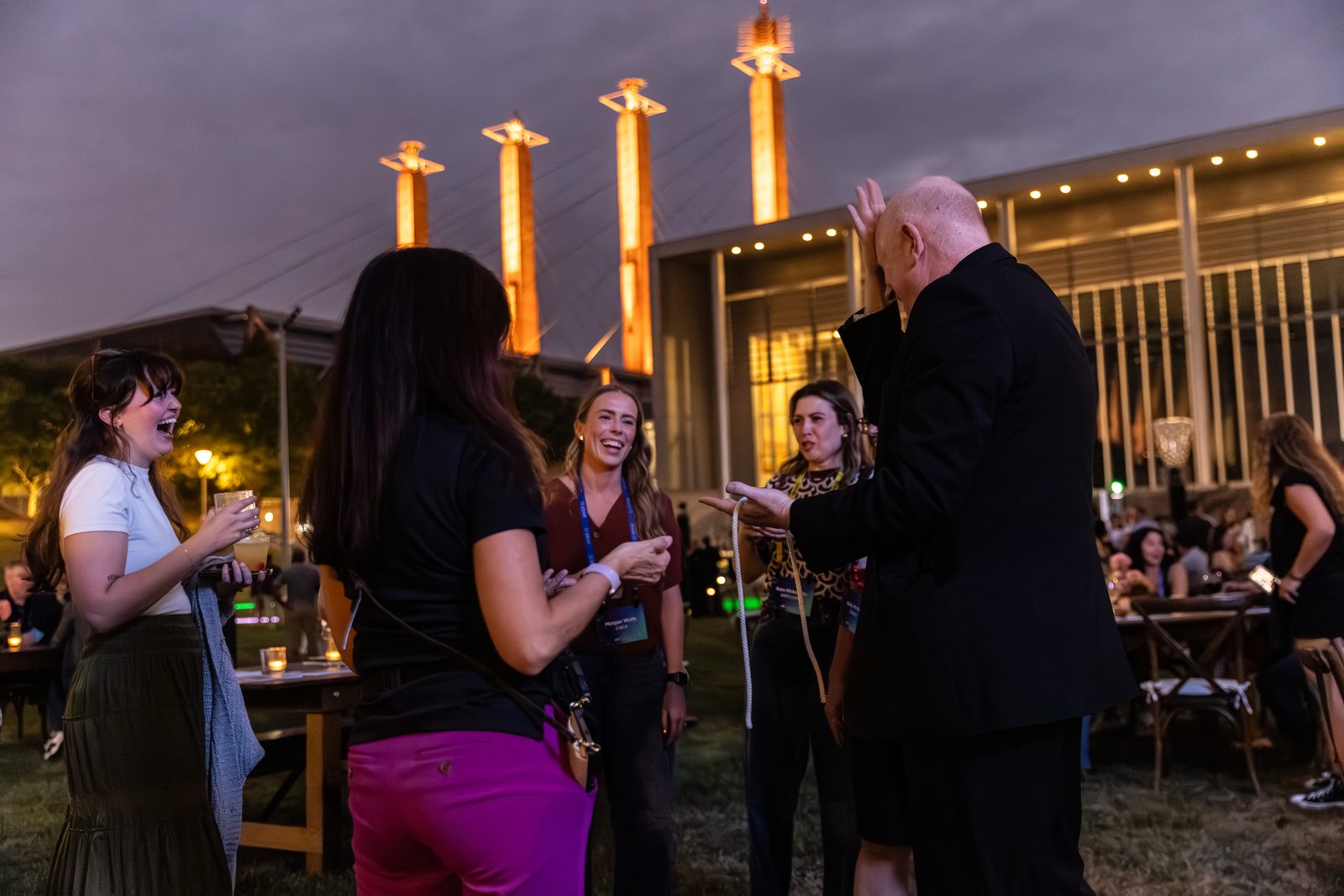 Outdoor corporate cocktail event at the Kauffman Performing Arts Center — Magic Scott engages a small group with sleight of hand